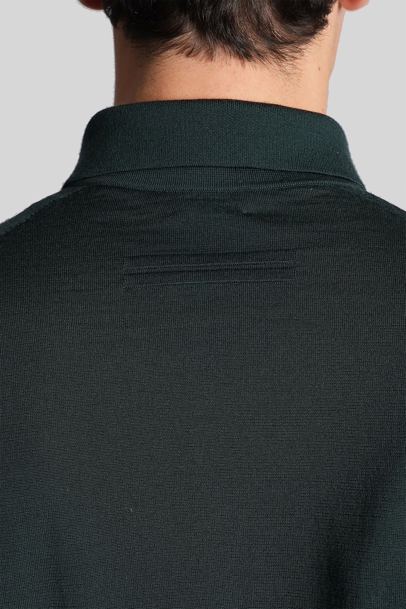 Polo in green wool
